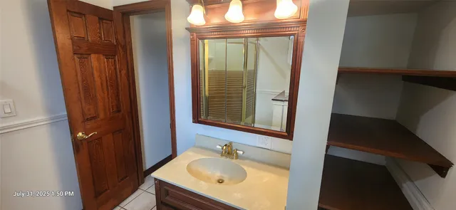 a bathroom with a sink a mirror and a shower