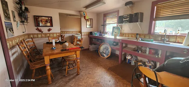 a view of a dining room with furniture window and outside view