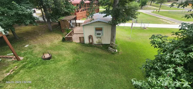 a view of a house with a backyard