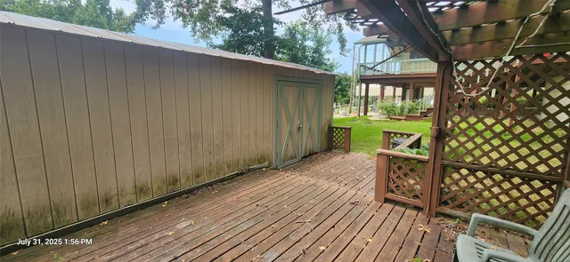 a street view with wooden fence and trees