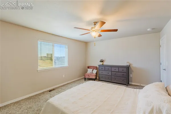 a view of walk in closet with clothes