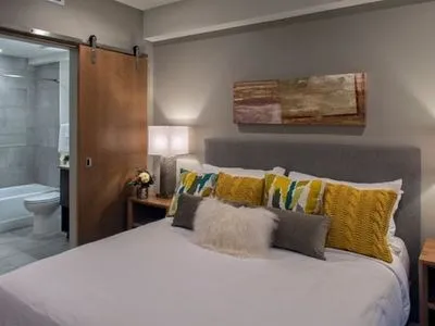 a bedroom with a bed and painting on the wall