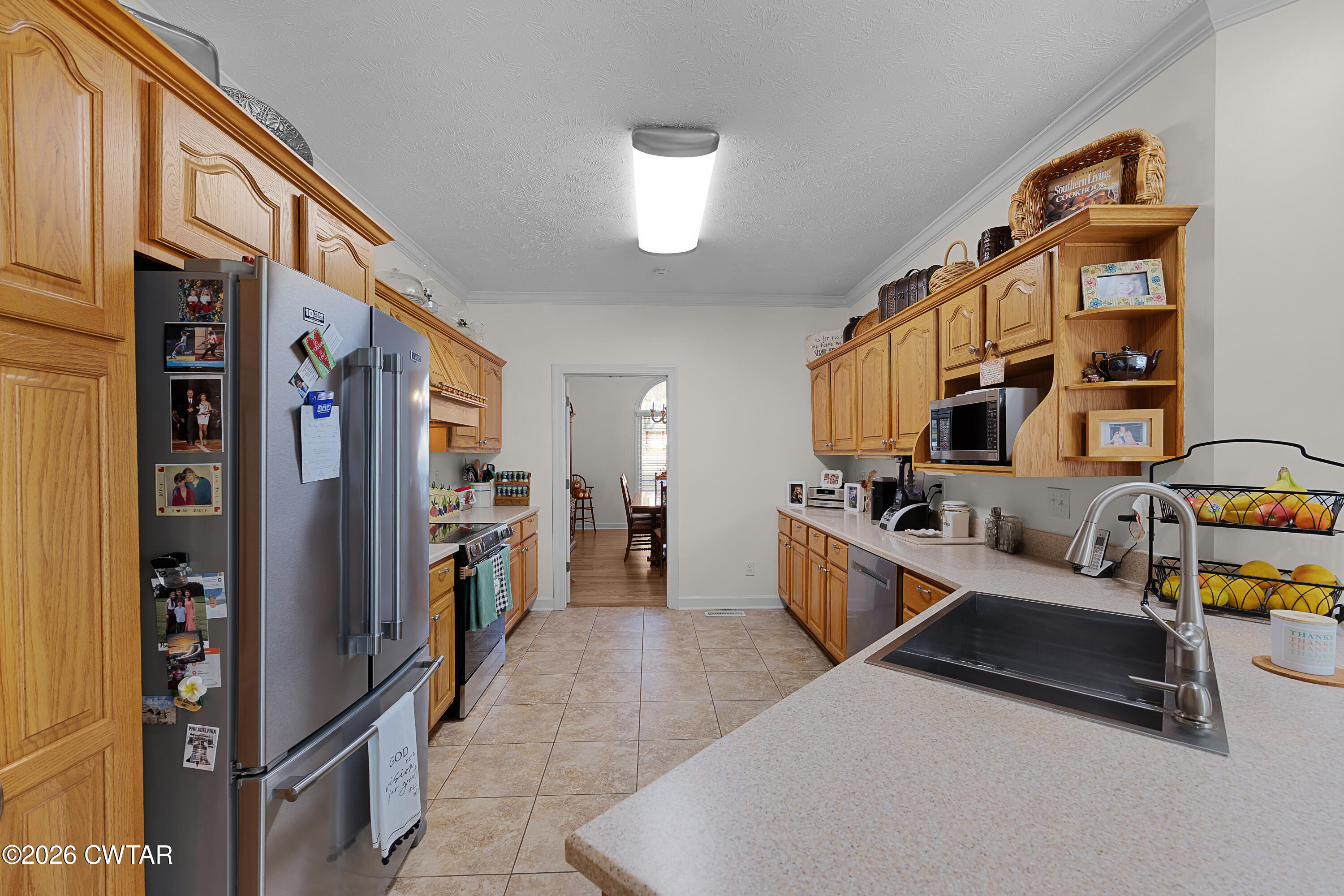 129 Pepper Tree Road Jackson, TN 38305 - Photo 14 of 35 a kitchen with stainless steel appliances granite countertop a refrigerator and a stove