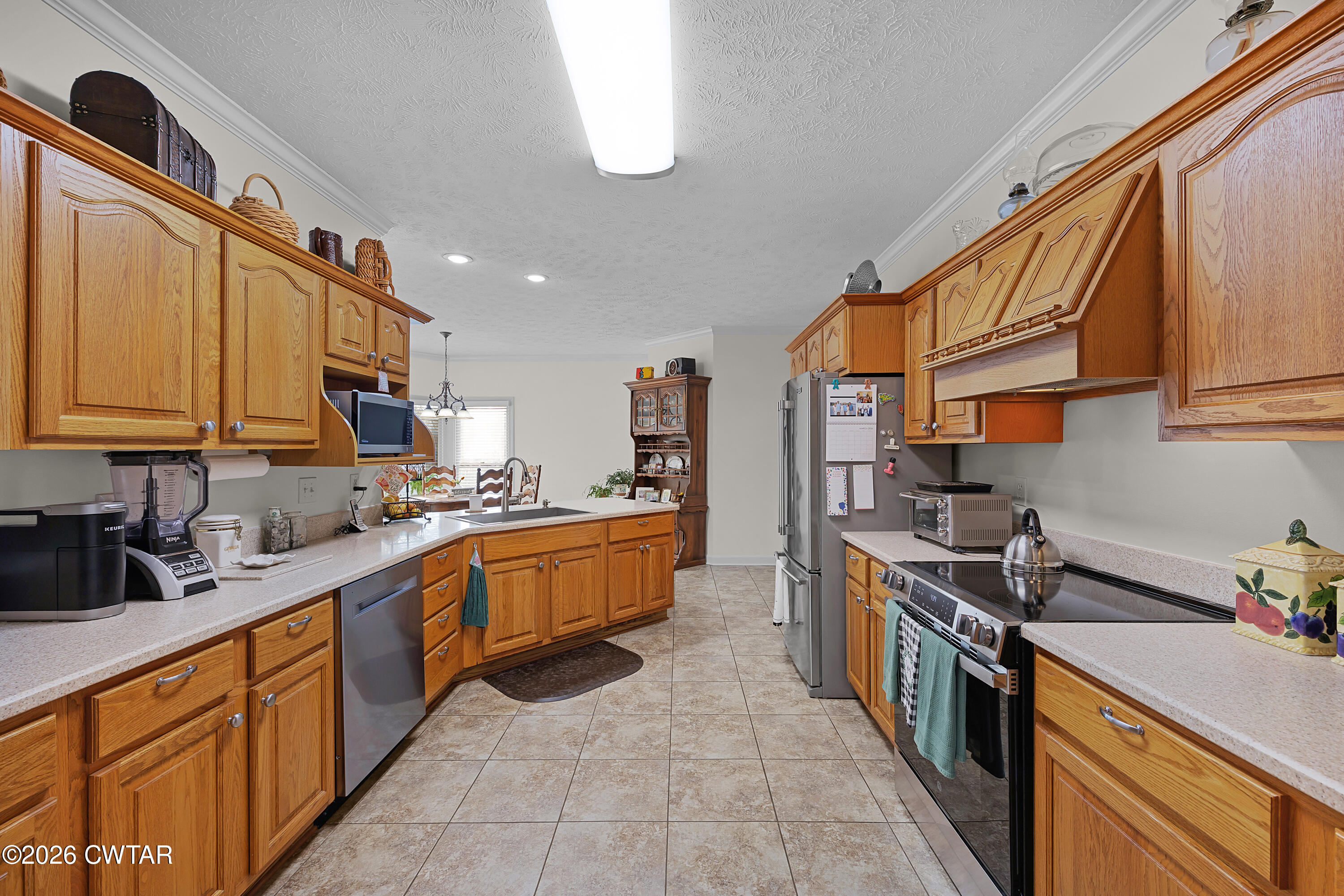 129 Pepper Tree Road Jackson, TN 38305 - Photo 15 of 35 a large kitchen with stainless steel appliances granite countertop a stove a sink dishwasher and cabinets