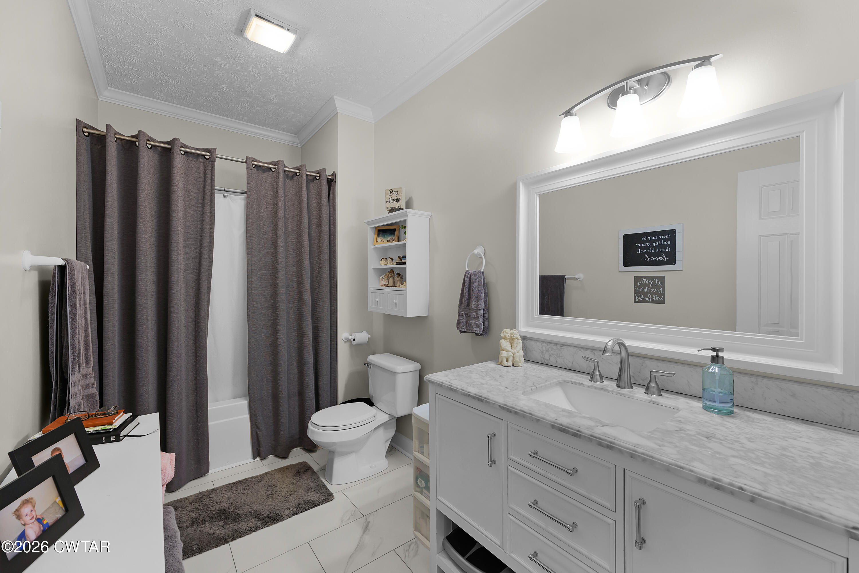 129 Pepper Tree Road Jackson, TN 38305 - Photo 21 of 35 a bathroom with double vanity sink a mirror and a toilet