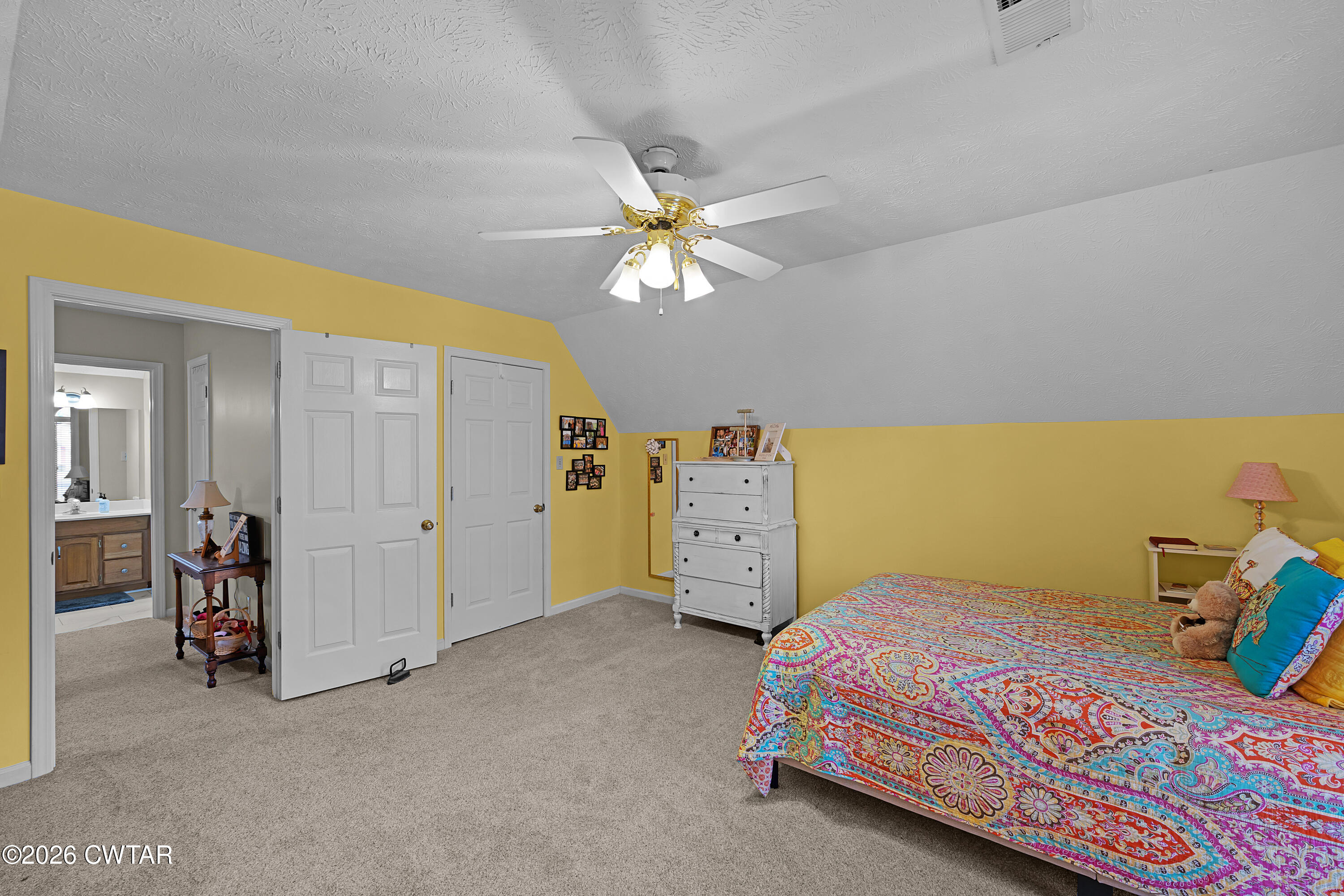129 Pepper Tree Road Jackson, TN 38305 - Photo 28 of 35 a bedroom with a bed and a chandelier