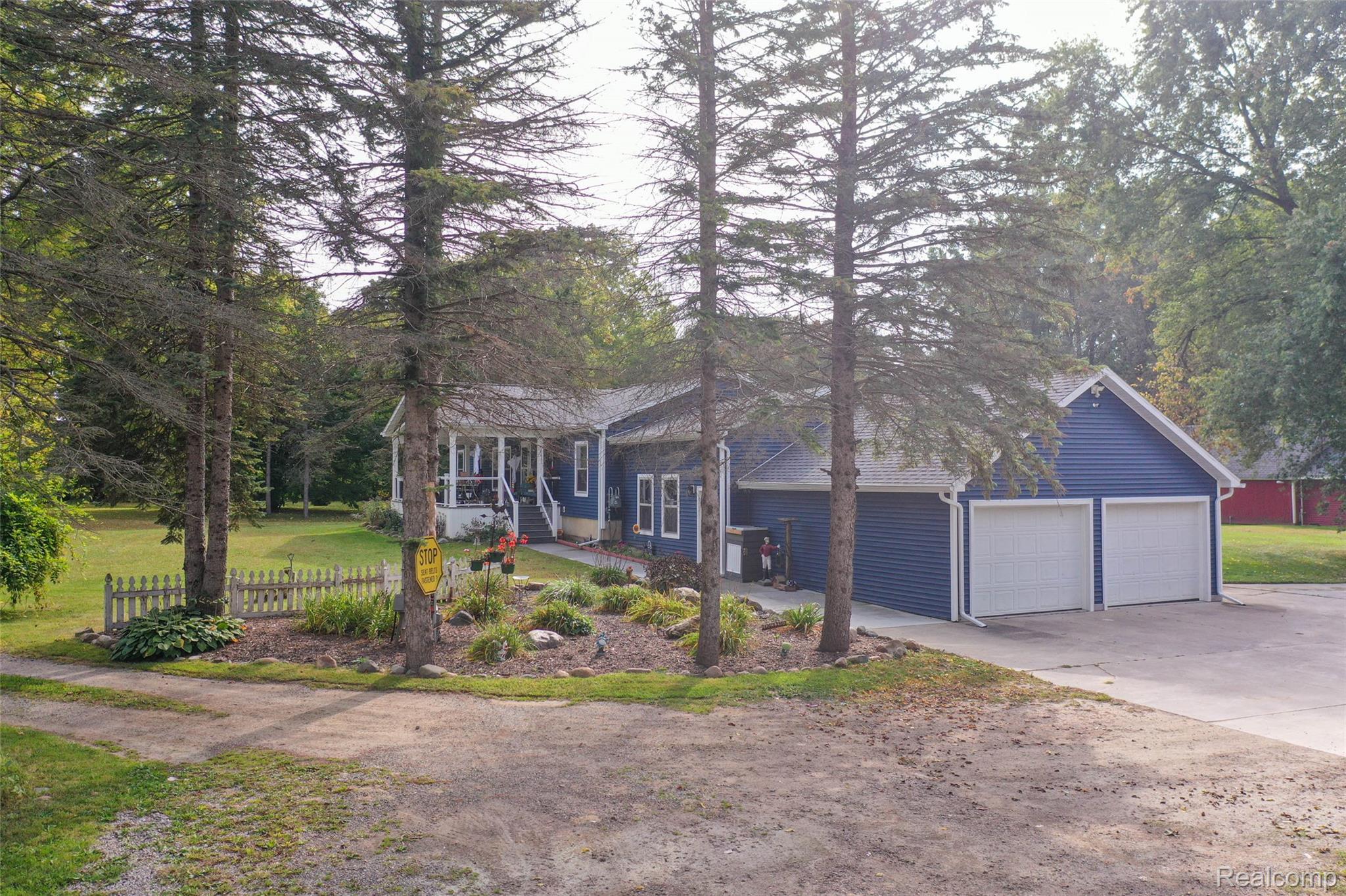 11141 Farrand Road Montrose, MI 48457 - Photo 30 of 51 View of front of property featuring concrete driveway and covered porch