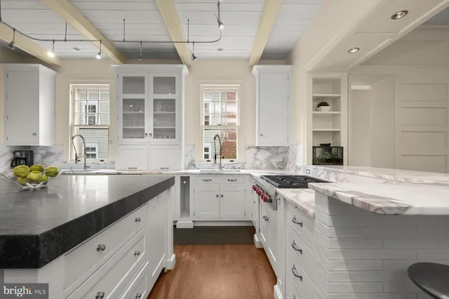 a kitchen with a sink stove and cabinets