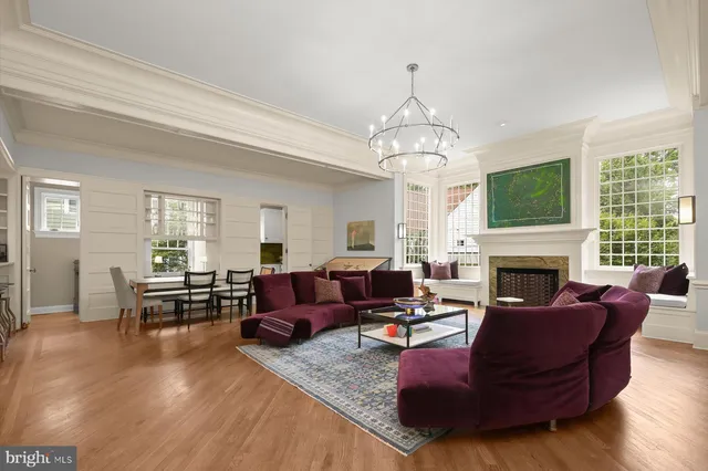 a living room with furniture fireplace and window