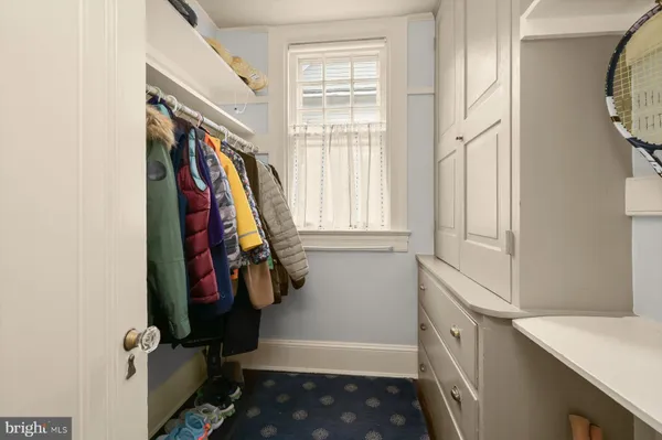 a view of staircase with railing and white walls