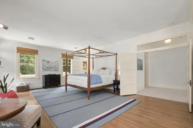 a living room with furniture large window and a fireplace
