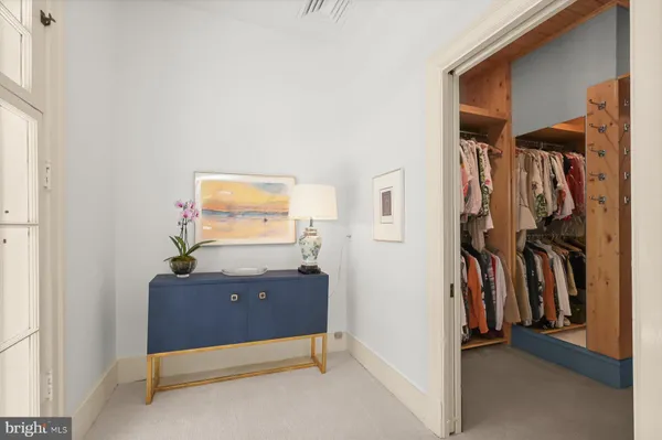 a bathroom with a granite countertop double vanity sink a mirror and a bathtub