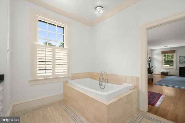 a bathroom with a sink a mirror a vanity and a window