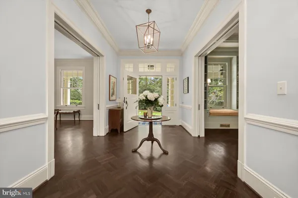 a living room with fireplace furniture and a chandelier