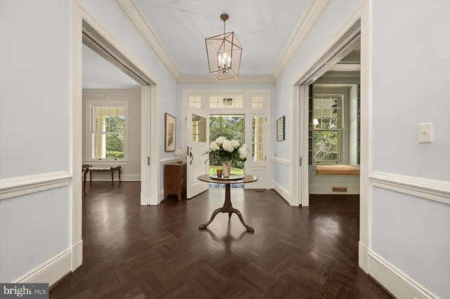 a living room with fireplace furniture and a chandelier