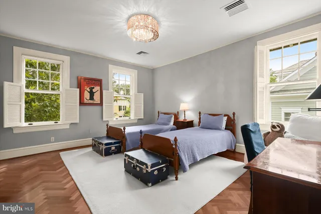 a living room with furniture a fireplace and a large window