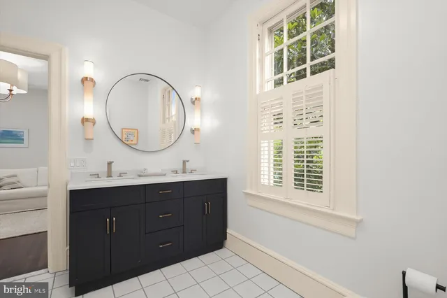 a spacious bedroom with a bed and a chair