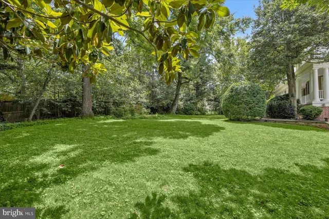 a wooden bench sitting in the middle of a yard