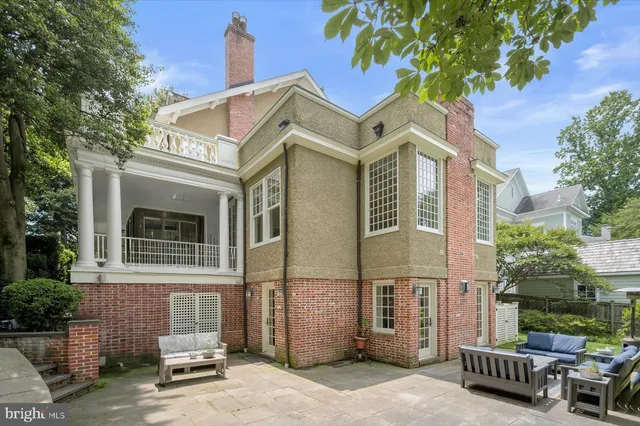 a view of a house with a yard and sitting area