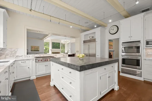 a kitchen with stainless steel appliances granite countertop a stove and a sink