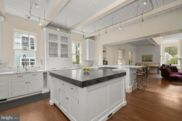 a kitchen with sink stove and cabinets