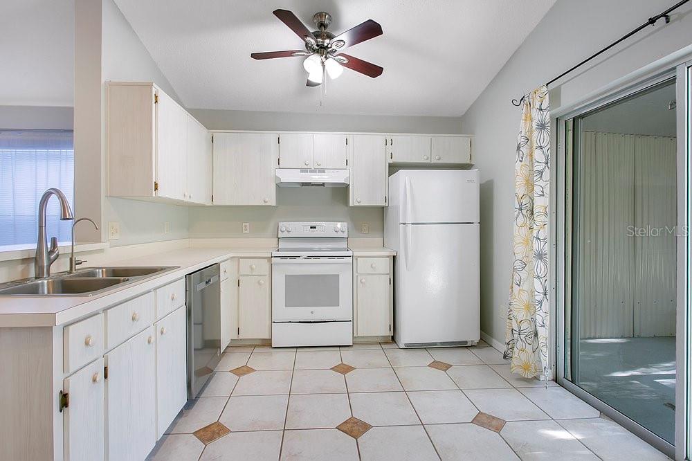 114 Sundance Court Winter Springs, FL 32708 - Photo 9 of 34 a kitchen with appliances cabinets a sink and a counter top space