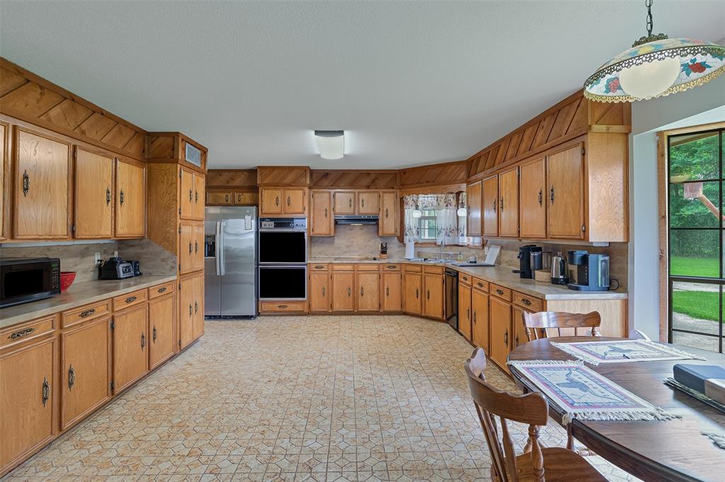 10307 Pirogue Road Oil City, LA 71061 - Photo 10 of 36 a large kitchen with stainless steel appliances granite countertop a large counter top space a sink stainless steel appliances and cabinets