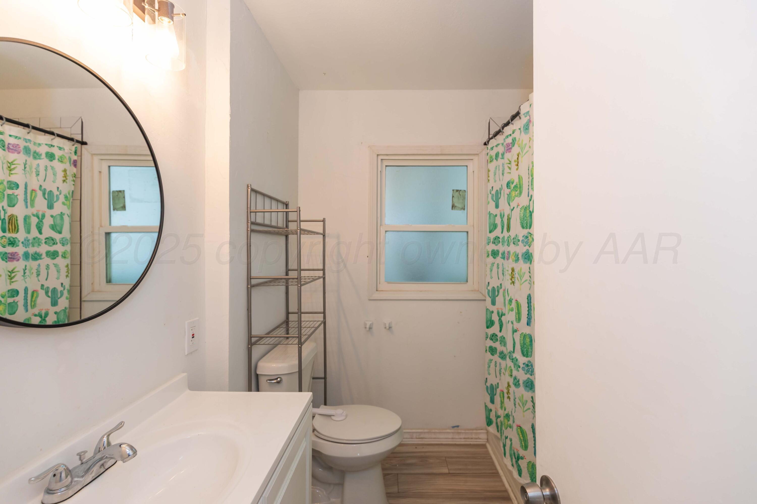 1214 Southwest 12th Avenue Amarillo, TX 79102 - Photo 15 of 25 a bathroom with a sink and a mirror