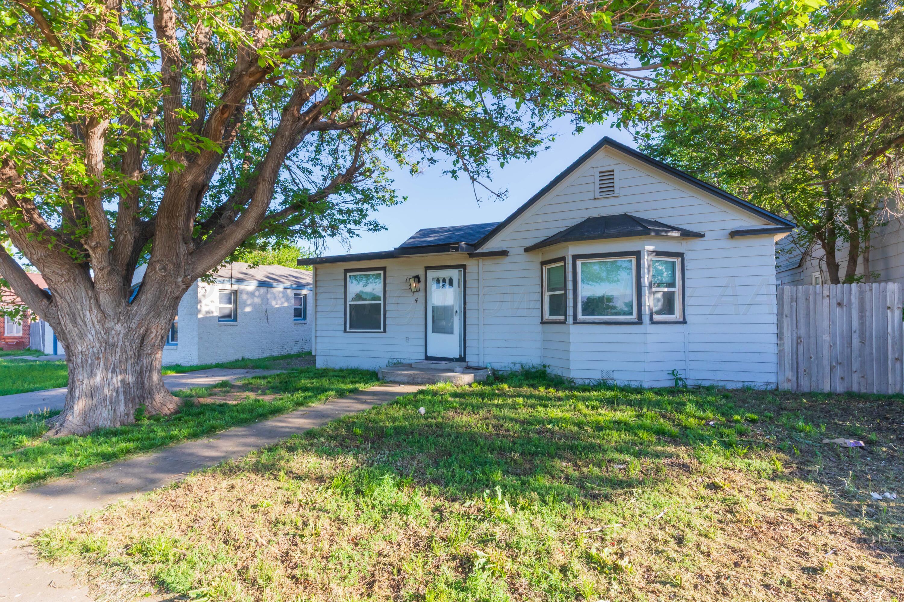 1214 Southwest 12th Avenue Amarillo, TX 79102 - Photo 2 of 25 a view of a yard in front of a house with large trees