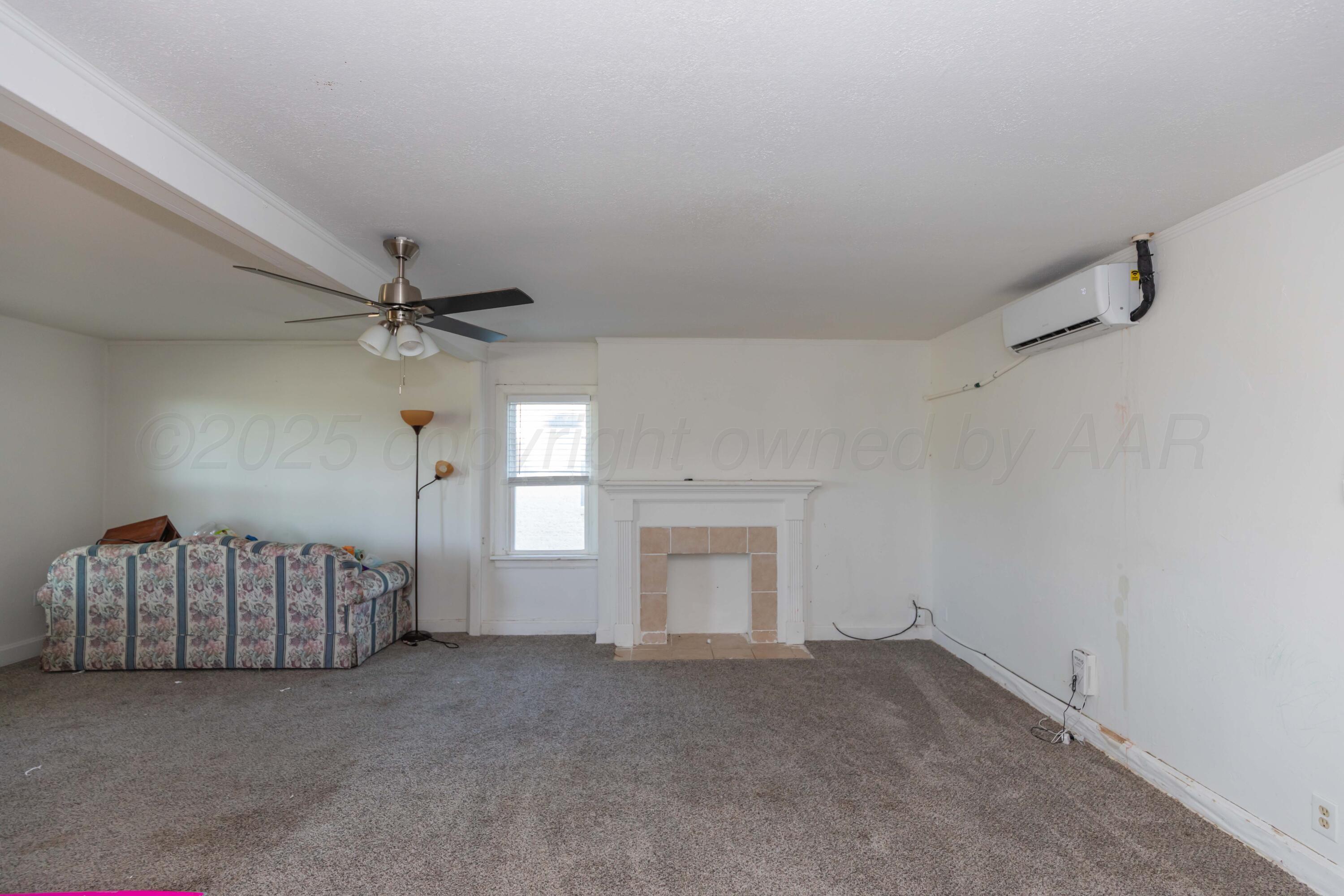 1214 Southwest 12th Avenue Amarillo, TX 79102 - Photo 5 of 25 a view of a livingroom with a ceiling fan and window