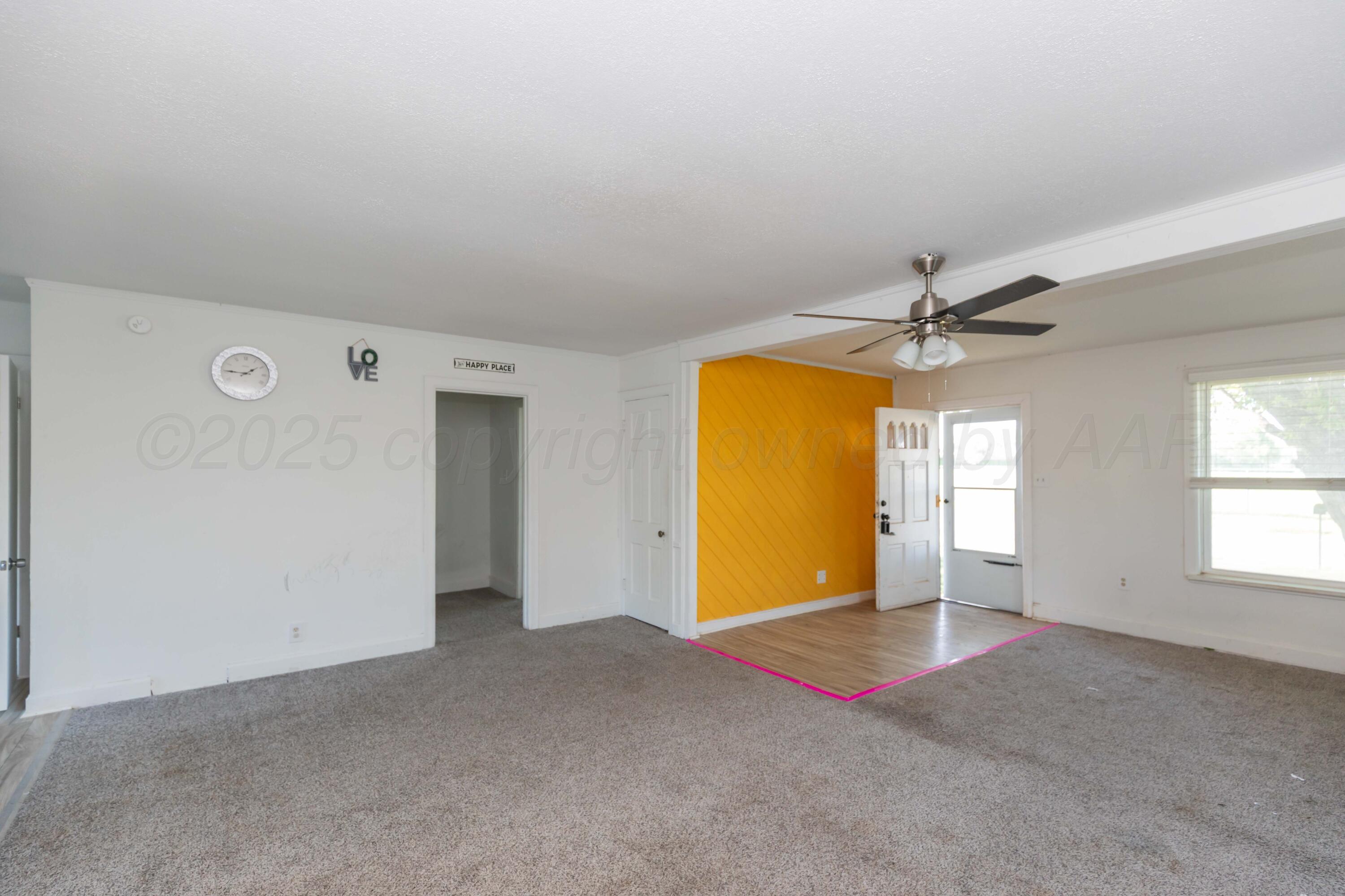 1214 Southwest 12th Avenue Amarillo, TX 79102 - Photo 6 of 25 a view of a big room with windows and chandelier fan