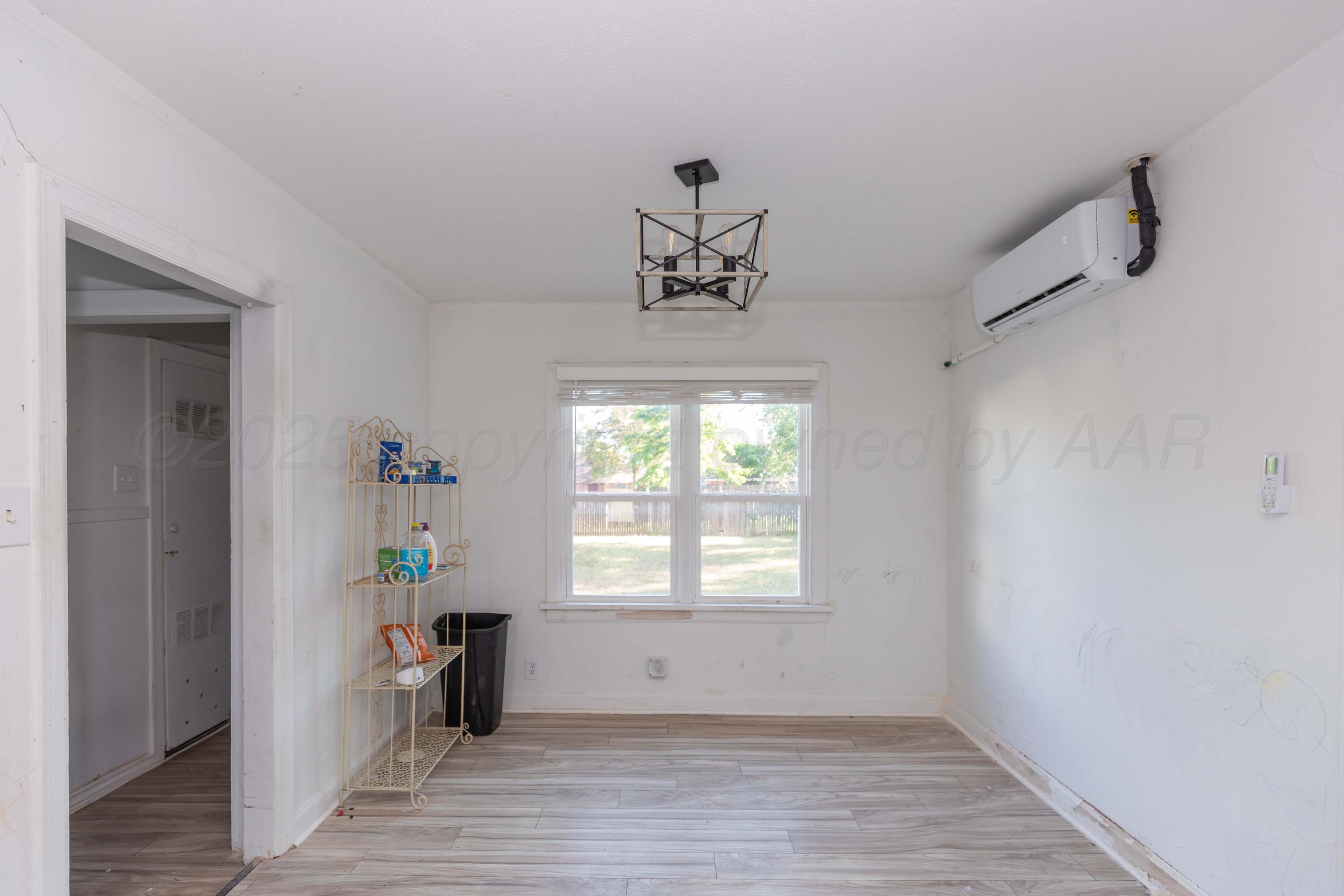 1214 Southwest 12th Avenue Amarillo, TX 79102 - Photo 7 of 25 wooden floor in an empty room with a window