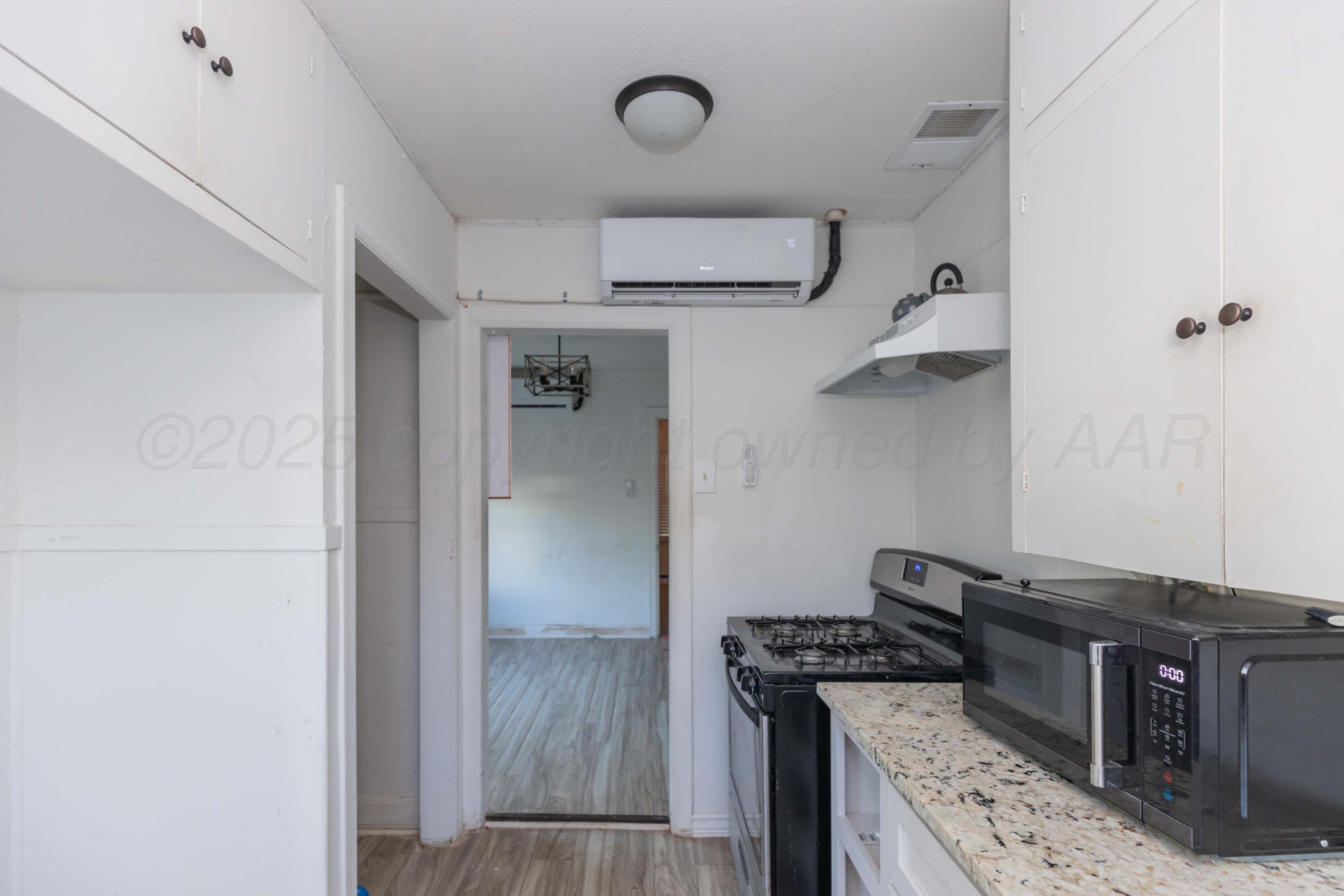 1214 Southwest 12th Avenue Amarillo, TX 79102 - Photo 10 of 25 a kitchen with stainless steel appliances granite countertop a stove and a refrigerator