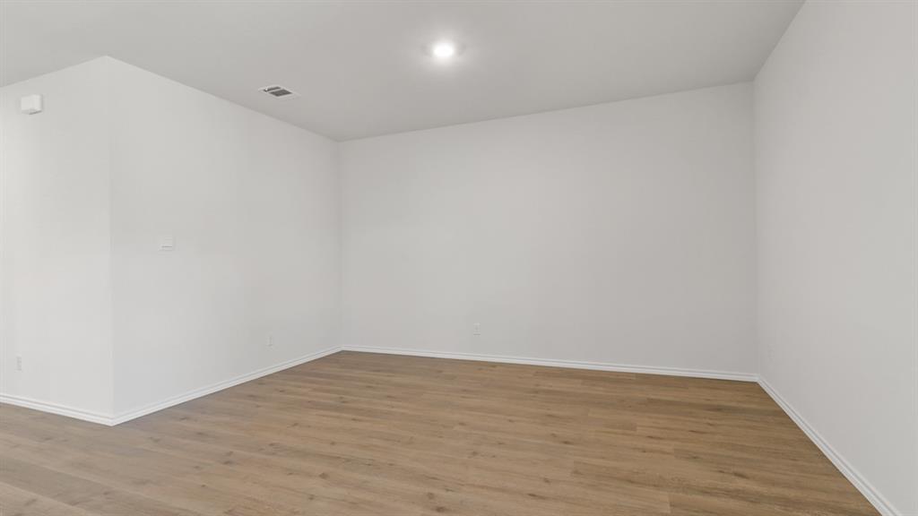 1913 Reveille Way Terrell, TX 75160 - Photo 3 of 35 Empty room featuring wood finished floors and baseboards