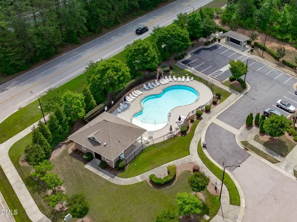 an aerial view of a swimming pool with a yard
