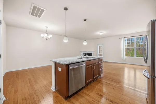 a view of a kitchen with a sink and wooden floor