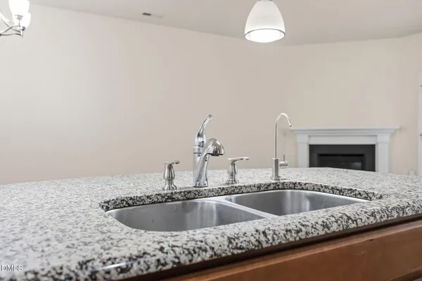 a kitchen with a sink and chandelier