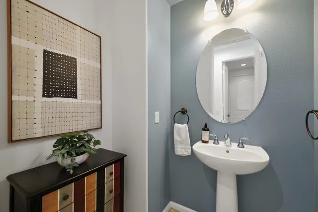 a bathroom with a sink a mirror and a toilet
