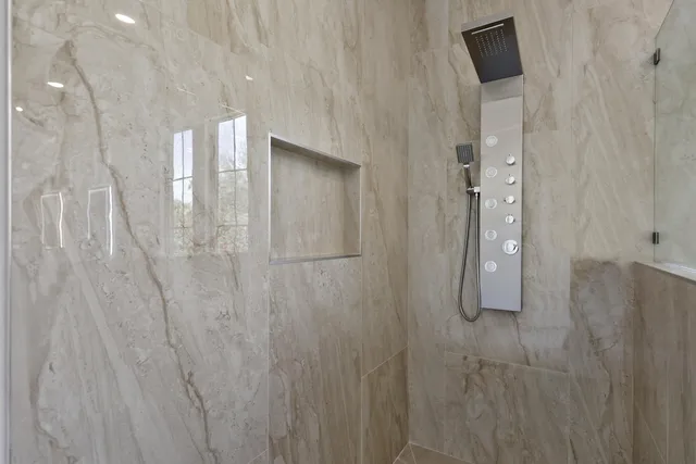 a spacious bedroom with a bed and a couch