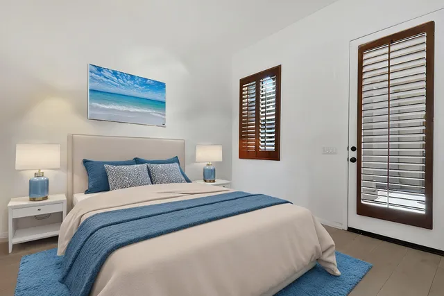 a bedroom with furniture and a large window