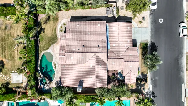 a view of a lush green field with mountains in the background