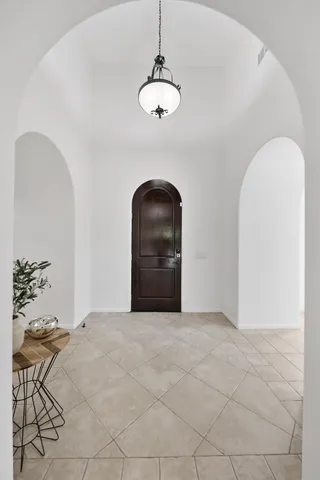 a view of a room with a chandelier fan and a rug