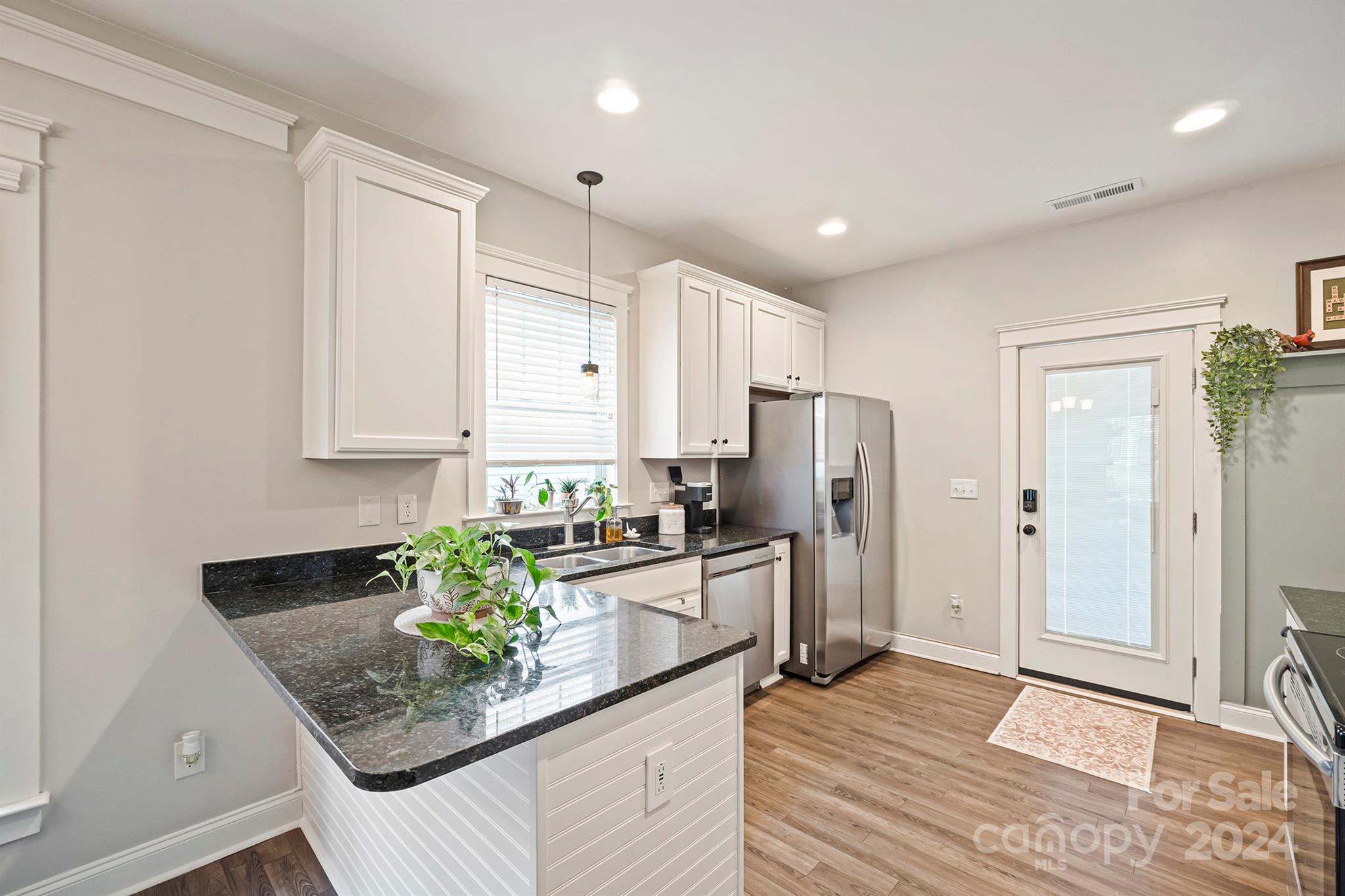 13516 Stumptown Road Huntersville, NC 28078 - Photo 11 of 37 a kitchen with stainless steel appliances granite countertop a sink refrigerator and cabinets