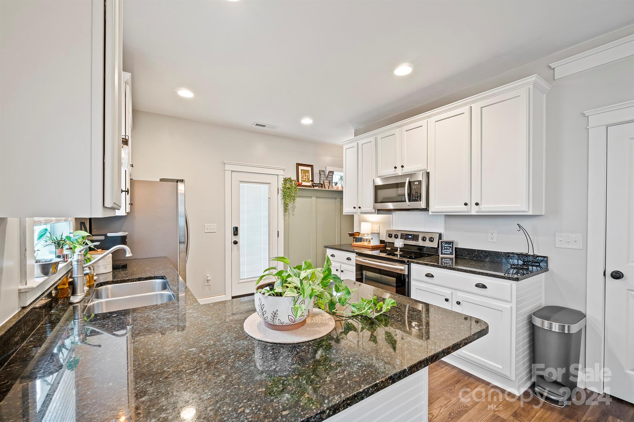 13516 Stumptown Road Huntersville, NC 28078 - Photo 12 of 37 a kitchen with a sink stove and chairs