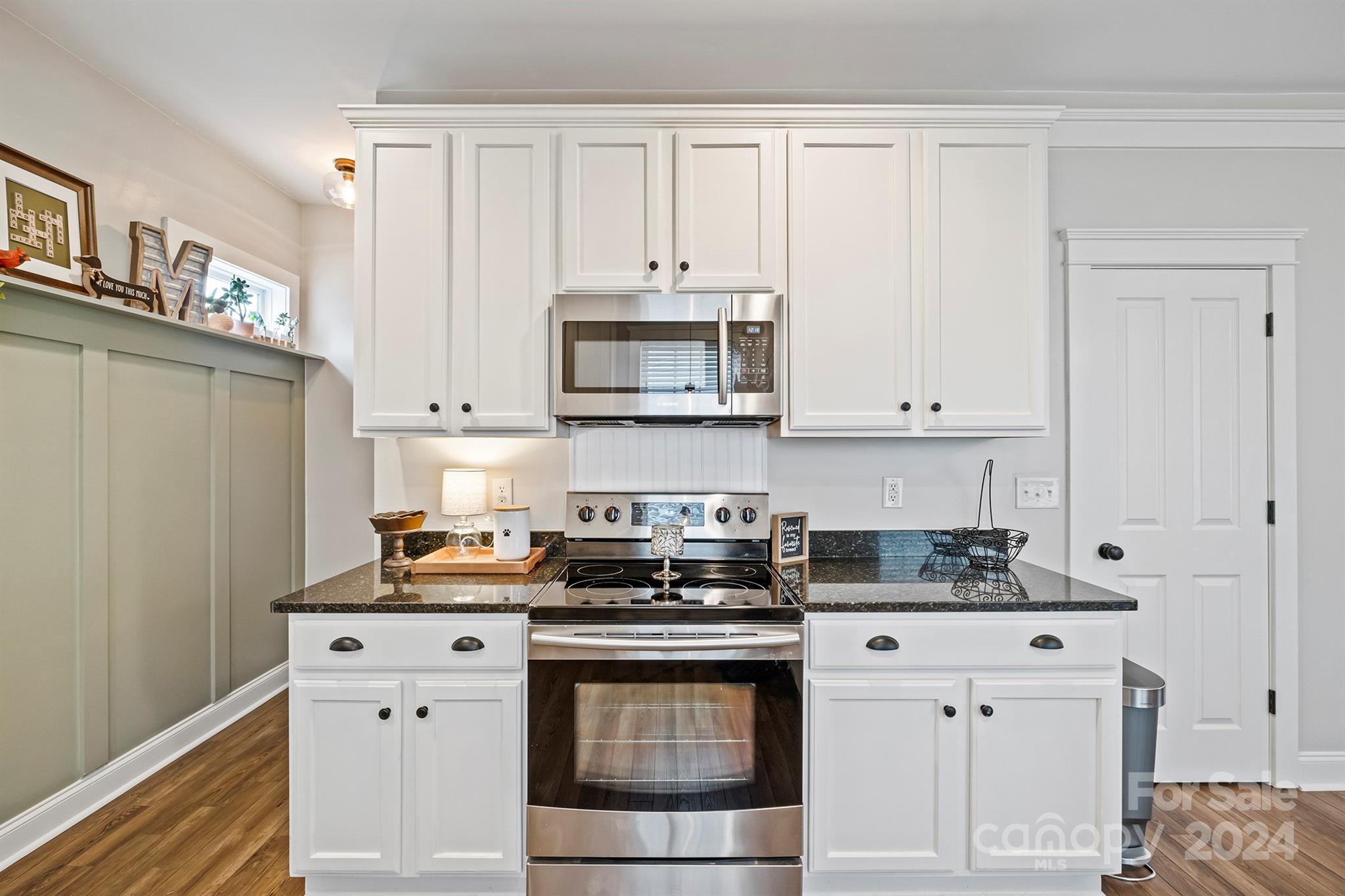13516 Stumptown Road Huntersville, NC 28078 - Photo 17 of 37 a kitchen with granite countertop white cabinets and stainless steel appliances