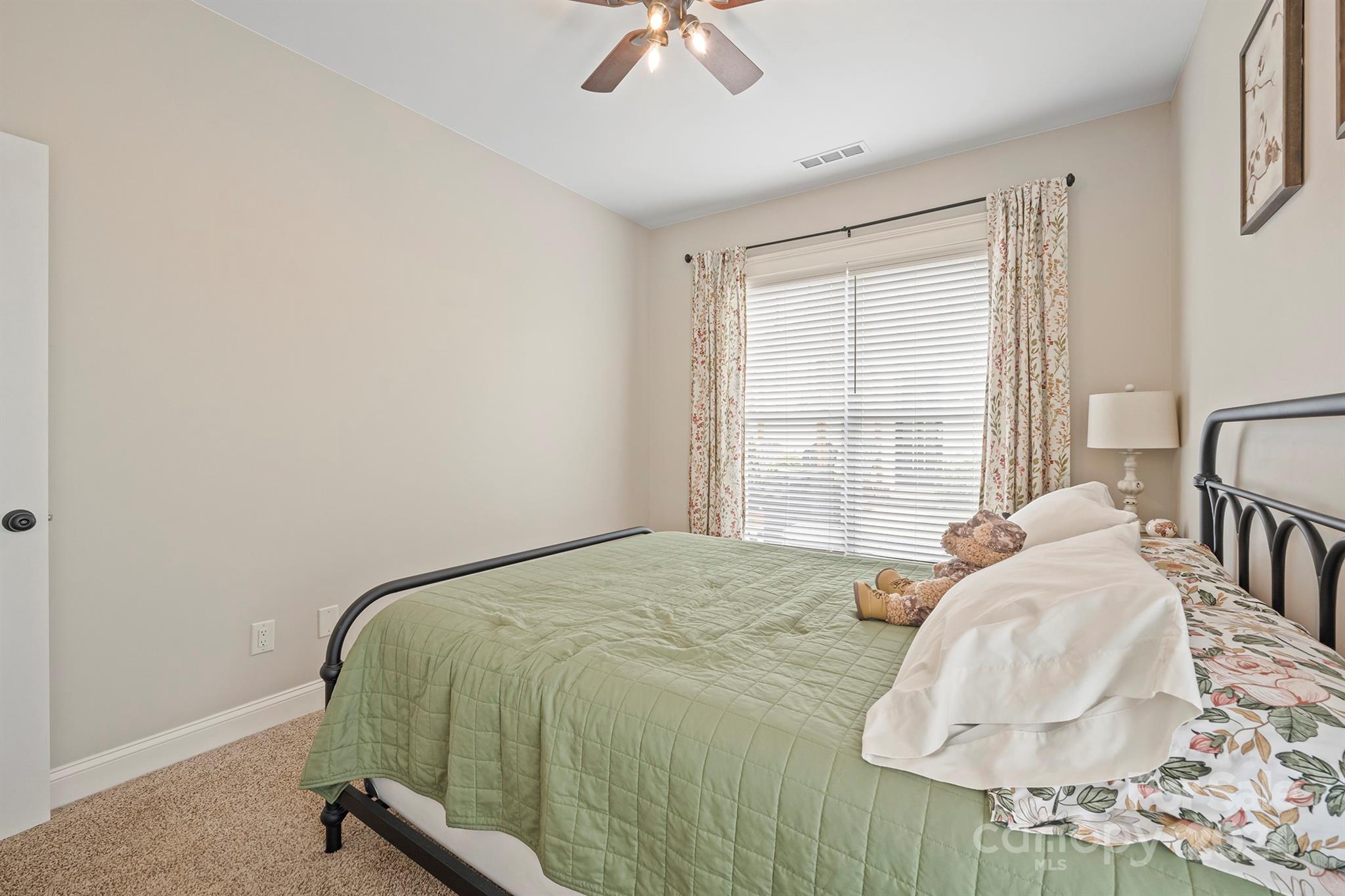 13516 Stumptown Road Huntersville, NC 28078 - Photo 20 of 37 a bedroom with a bed and a chandelier