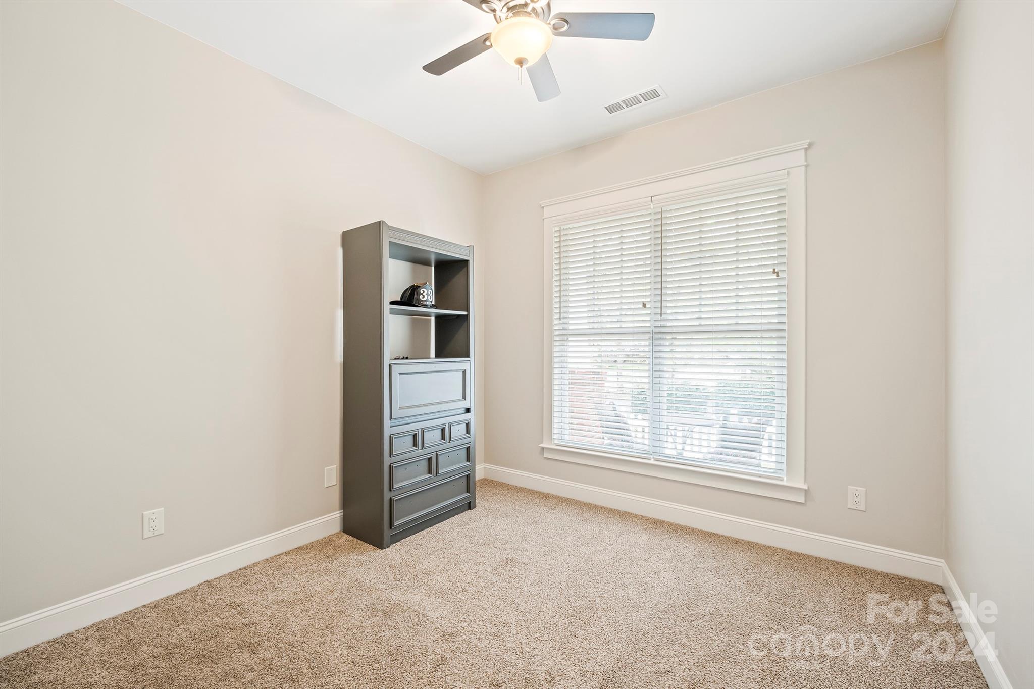13516 Stumptown Road Huntersville, NC 28078 - Photo 21 of 37 an empty room with windows and ceiling fan