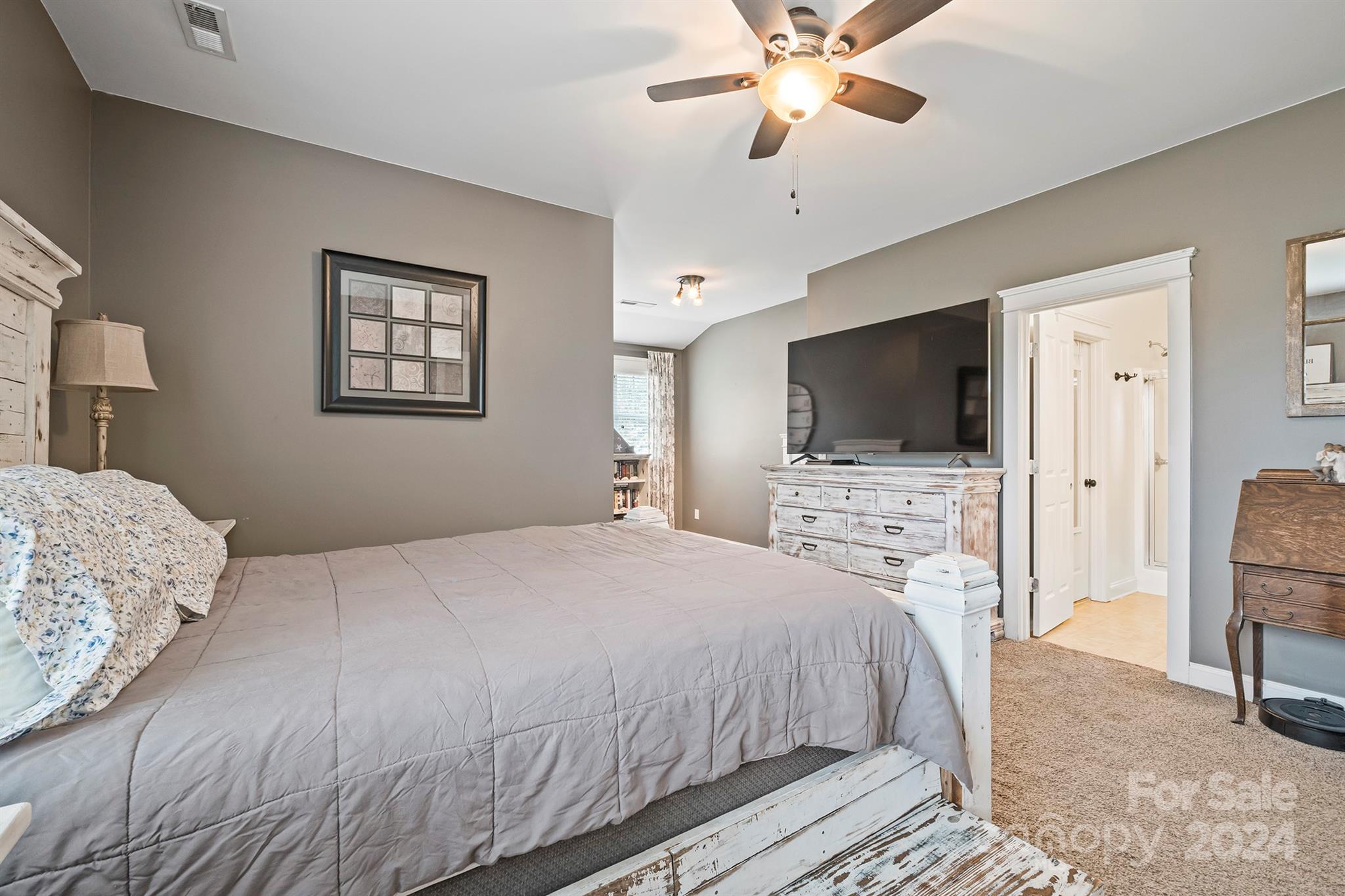 13516 Stumptown Road Huntersville, NC 28078 - Photo 27 of 37 a bedroom with a bed and a flat screen tv