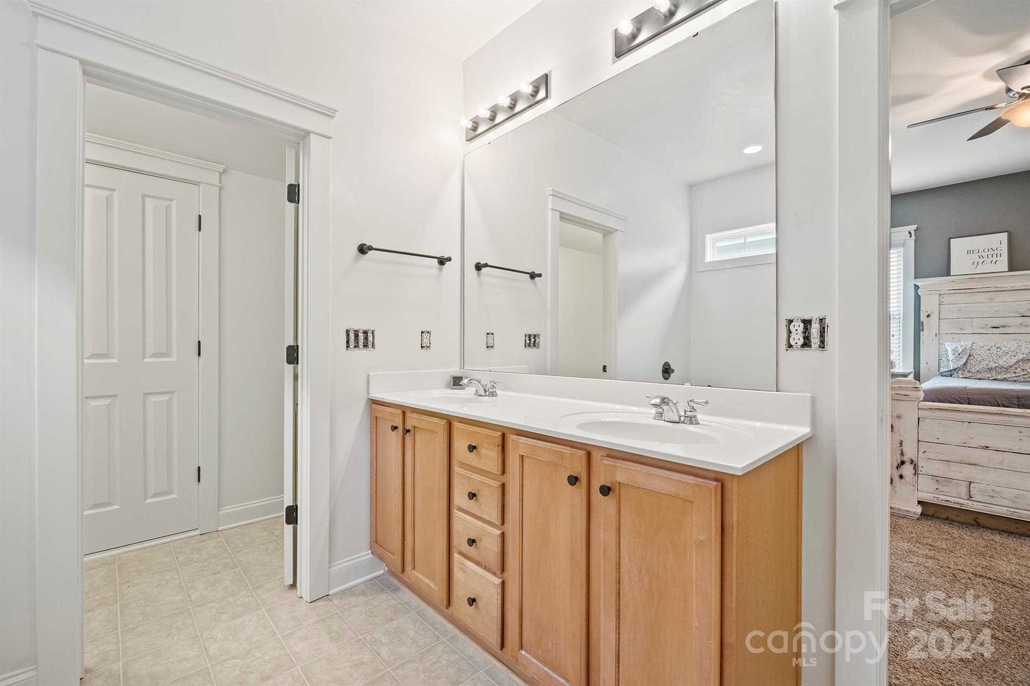 13516 Stumptown Road Huntersville, NC 28078 - Photo 32 of 37 a spacious bathroom with a granite countertop sink and a mirror