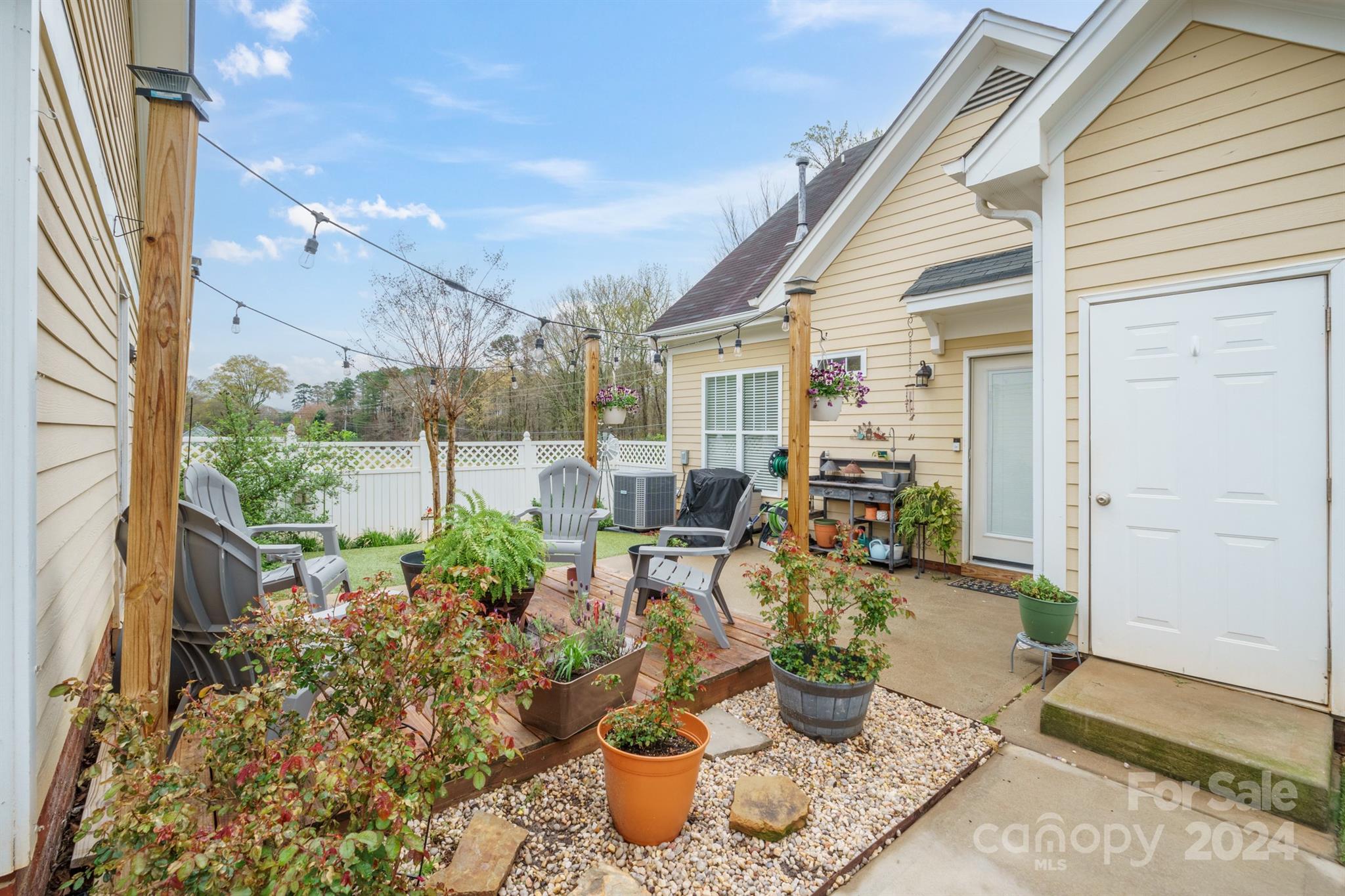 13516 Stumptown Road Huntersville, NC 28078 - Photo 36 of 37 a view of a patio with table and chairs potted plants